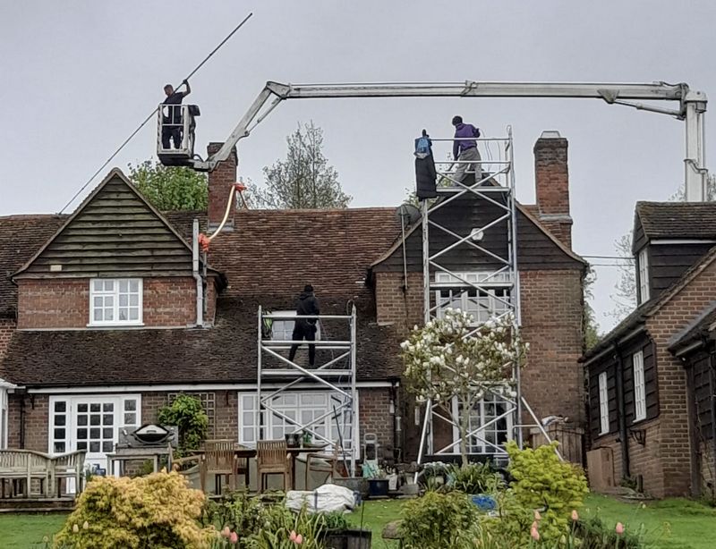The Roof Moss Cleaners using cherry picker and scaffolding to clean roof safely and professionally in Fareham, Hampshire
